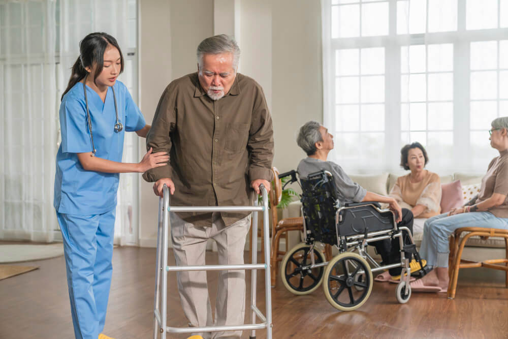 Caregiver assisting resident at Maple House